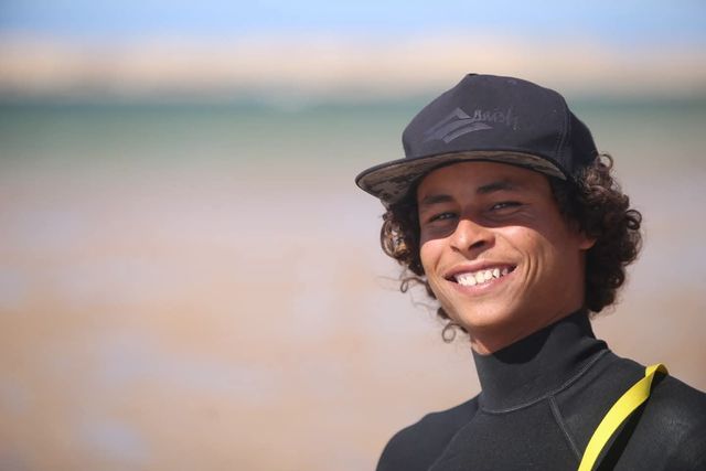 Abdou, kitesurfing and wingfoiling instructor, smiling at the lagoon